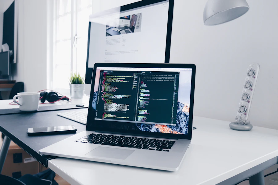 MacBook on a clean desk showing a code editor with a custom theme build